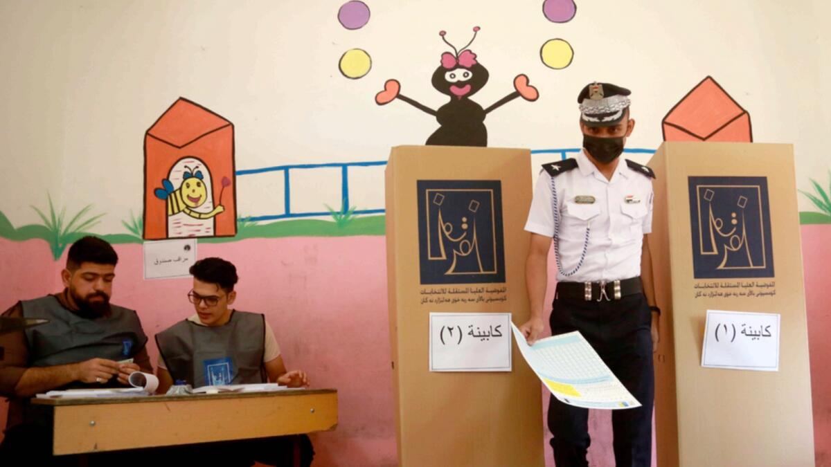 An Iraqi traffic policeman casts his vote at a polling center ahead of Iraq's parliamentary elections in Basra. — AP