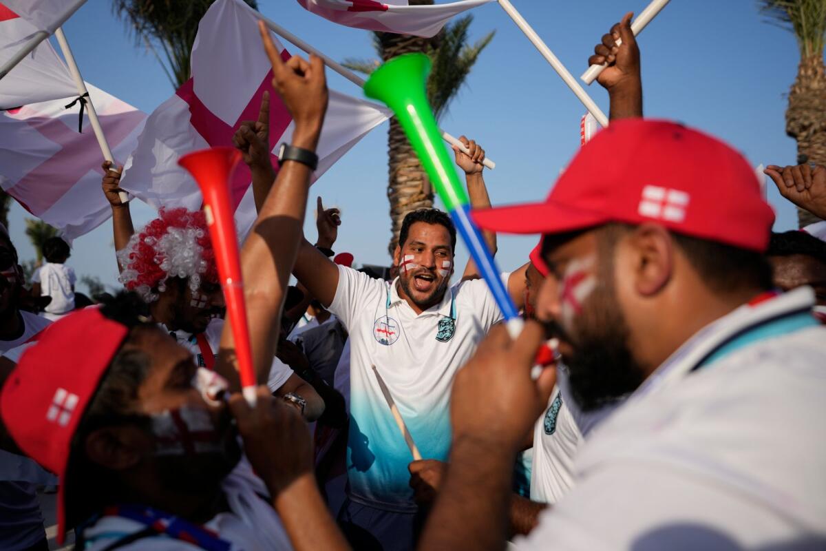 England fans cheer at flag plaza in Doha, Qatar. — AP