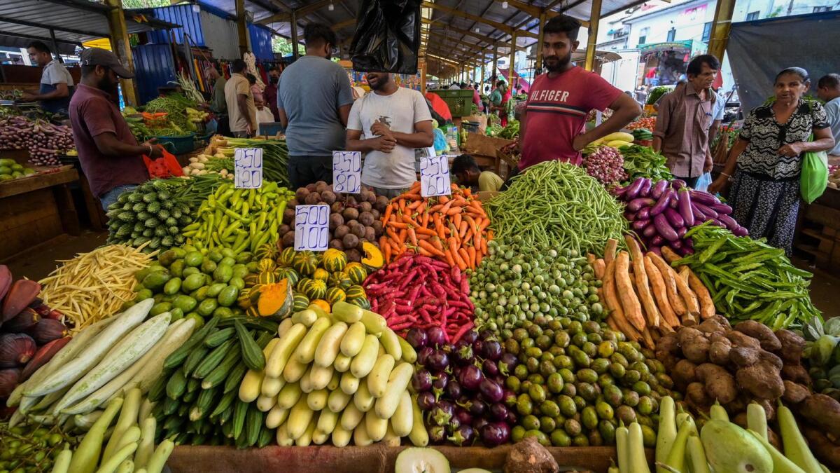 Vendors selling vegetables wait for customers at a market in Colombo. Sri Lanka has been facing tremendous economic and social challenges with a severe recession amid high inflation. — AFP