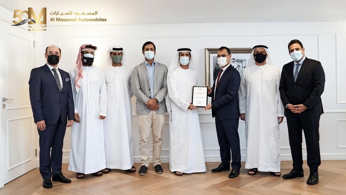 Masaood Ahmed Al Masaood, chairman of Al Masaood Group, receives the Nissan Excellence Award from Nissan Motor Corporation senior executives.