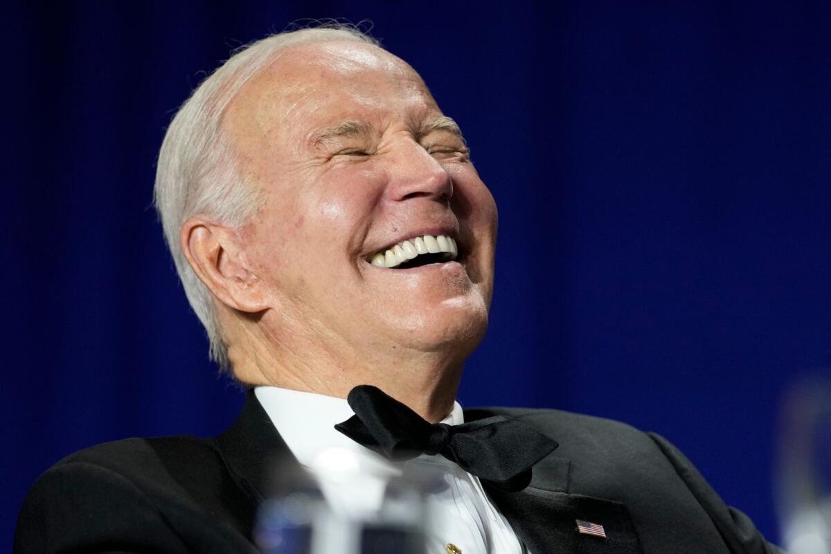 President Joe Biden laughs as comedian Roy Wood Jr., a correspondent for 'The Daily Show,' speaks during the White House Correspondents' Association dinner at the Washington Hilton in Washington, on Saturday. — AP
