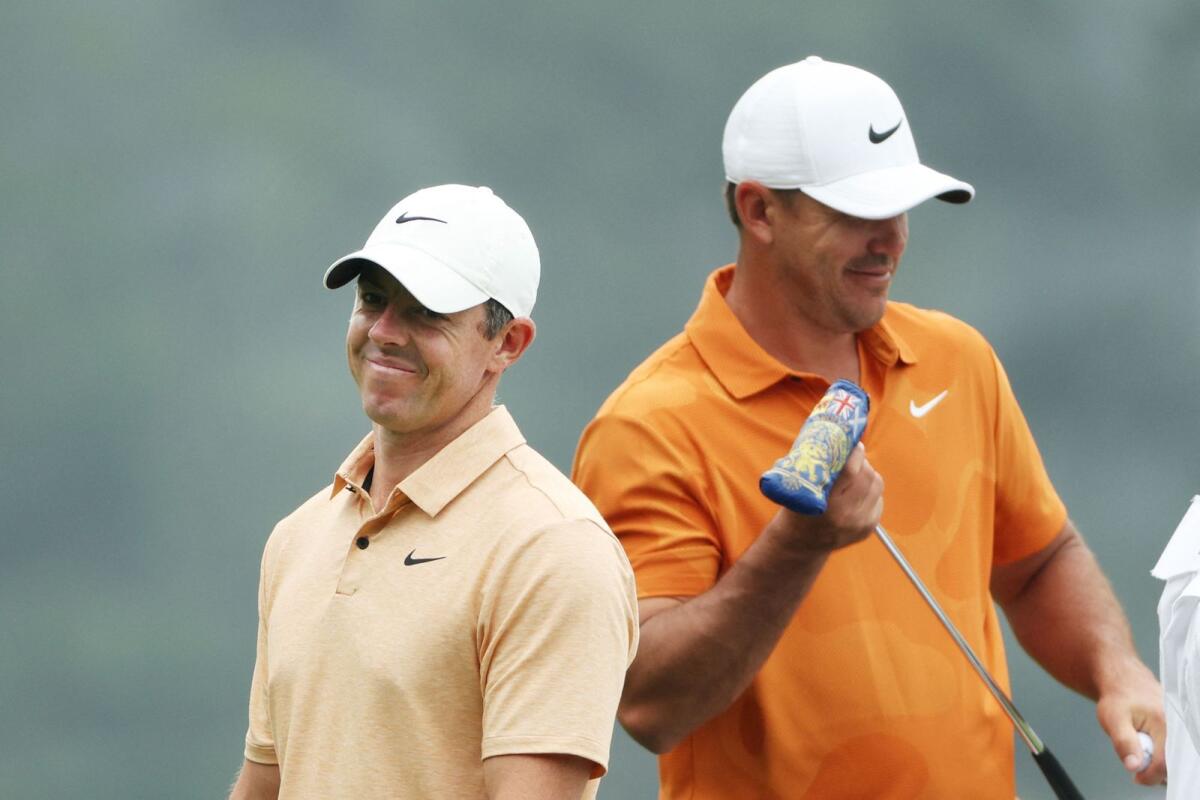 Rory McIlroy of Northern Ireland and Brooks Koepka of the United States during a practice round prior to the 2023 Masters Tournament at Augusta National Golf Club on April 4. - AFP