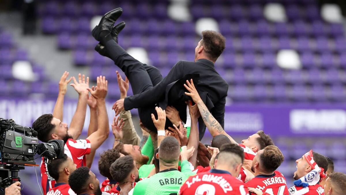 Atletico players celebrate La Liga crown by throwing manager Diego Simeone in the air. — Twitter