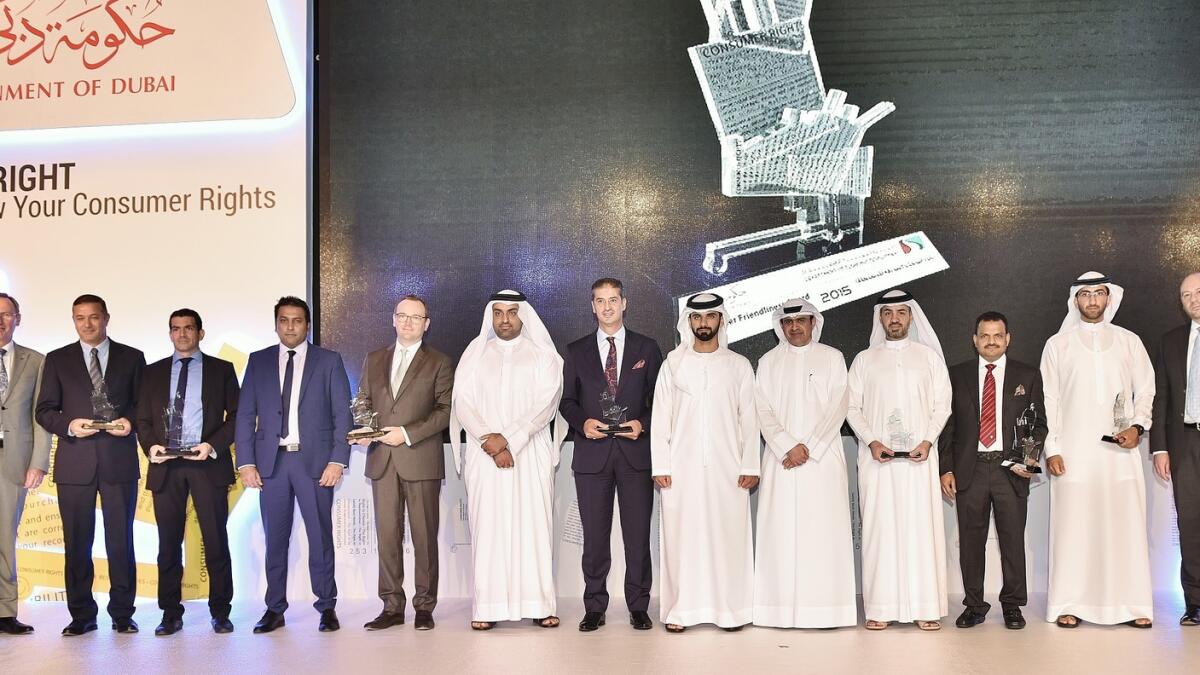 Shaikh Mansour and other officials with the winners of the Department of Economic Development’s Consumer Friendliness Index in Dubai on Wednesday. — Supplied photo
