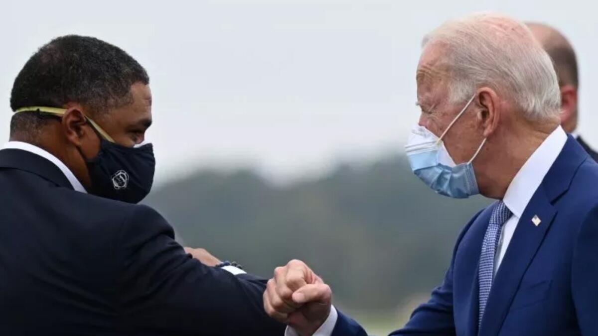 Joe Biden is greeted by Louisiana Congressman Cedric Richmond as he arrives in Columbus, Georgia, on October 27. AFP