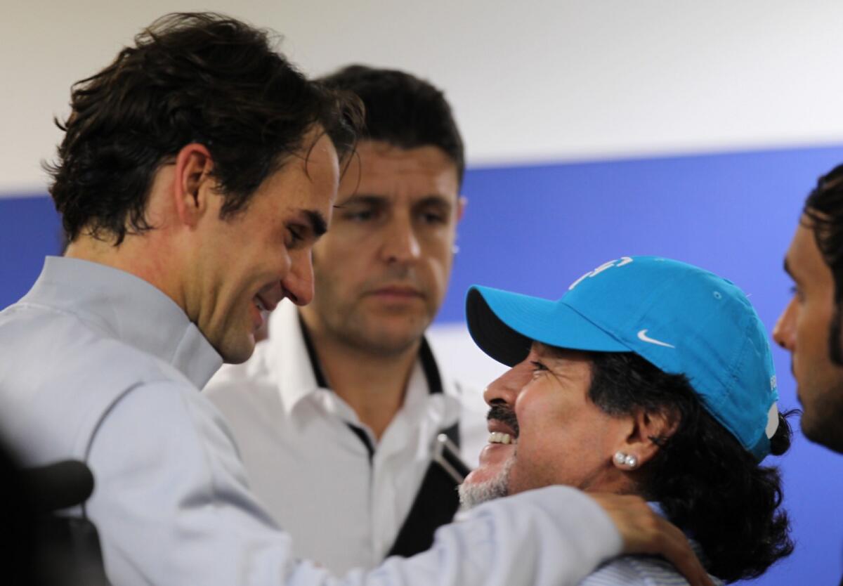 Roger Federer (left) with Argentine football legend Diego Maradona in Dubai. — KT file