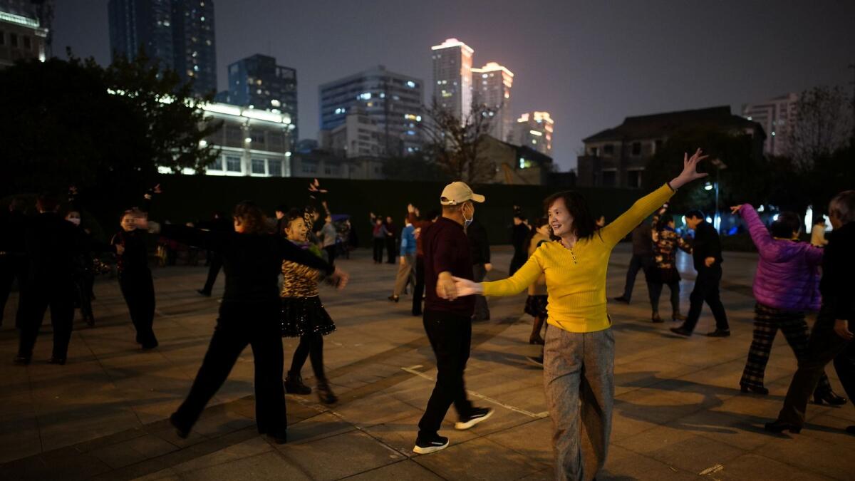 People dance at a park at night, almost a year after the global outbreak of the coronavirus disease in Wuhan, Hubei province, China.