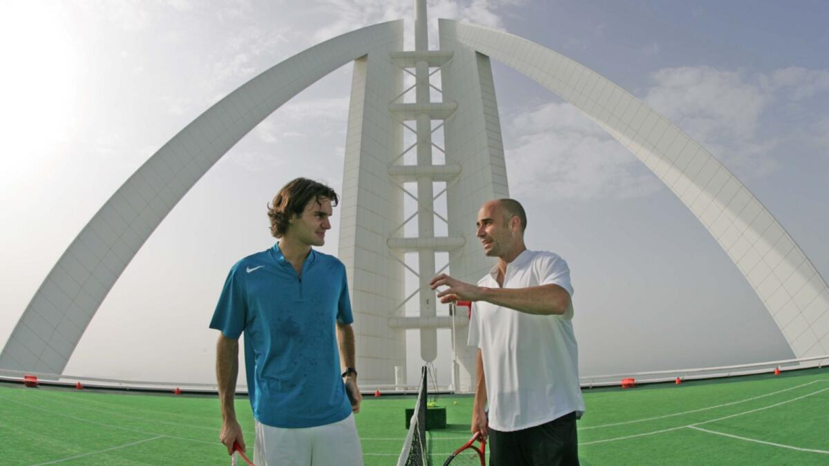 Roger Federer (left) and American tennis legend Andre Agassi prepare for a friendly 'hit' on the world's most unique tennis court, the Helipad of the Burj Al Arab, the world's most luxurious hotel in 2005. — AFP file
