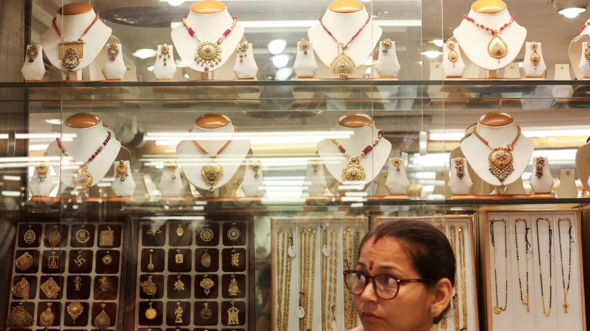 A saleswoman waits for customers at a jewellery shop in the old quarters of Delhi, India, on May 24, 2023. -- Reuters