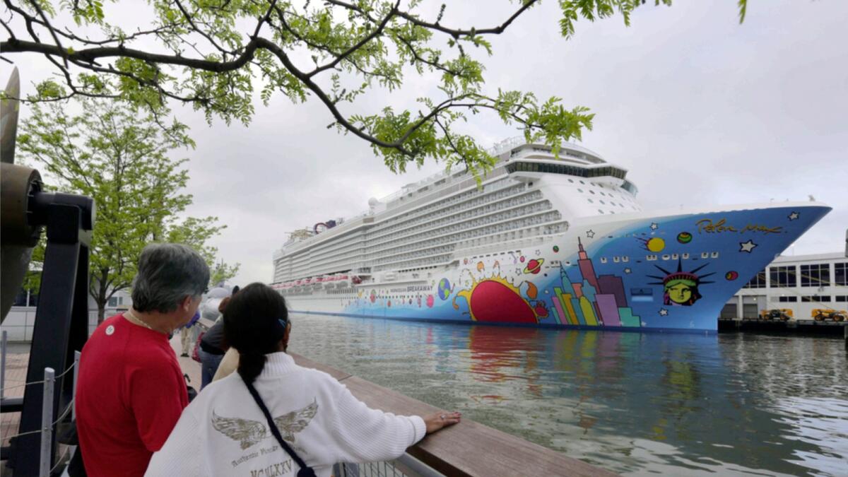 People pause to look at Norwegian Cruise Line's ship, Norwegian Breakaway, on the Hudson River, in New York, in 2013. Ten people aboard the cruise ship have tested positive for Covid-19. — AP file