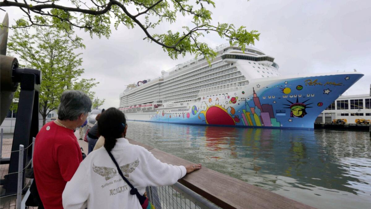 People pause to look at Norwegian Cruise Line's ship, Norwegian Breakaway, on the Hudson River, in New York, in 2013. Ten people aboard the cruise ship have tested positive for Covid-19. — AP file