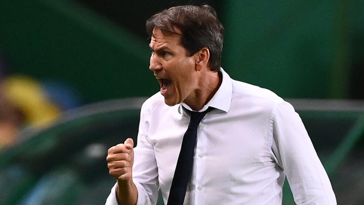 Lyon's coach Rudi Garcia celebrates his team's win at the end of the Uefa Champions League quarterfinal football match against Manchester City. -- AFP