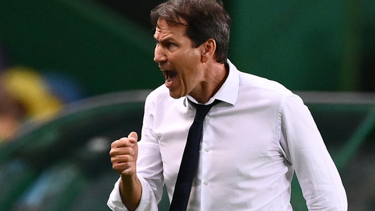 Lyon's coach Rudi Garcia celebrates his team's win at the end of the Uefa Champions League quarterfinal football match against Manchester City. -- AFP
