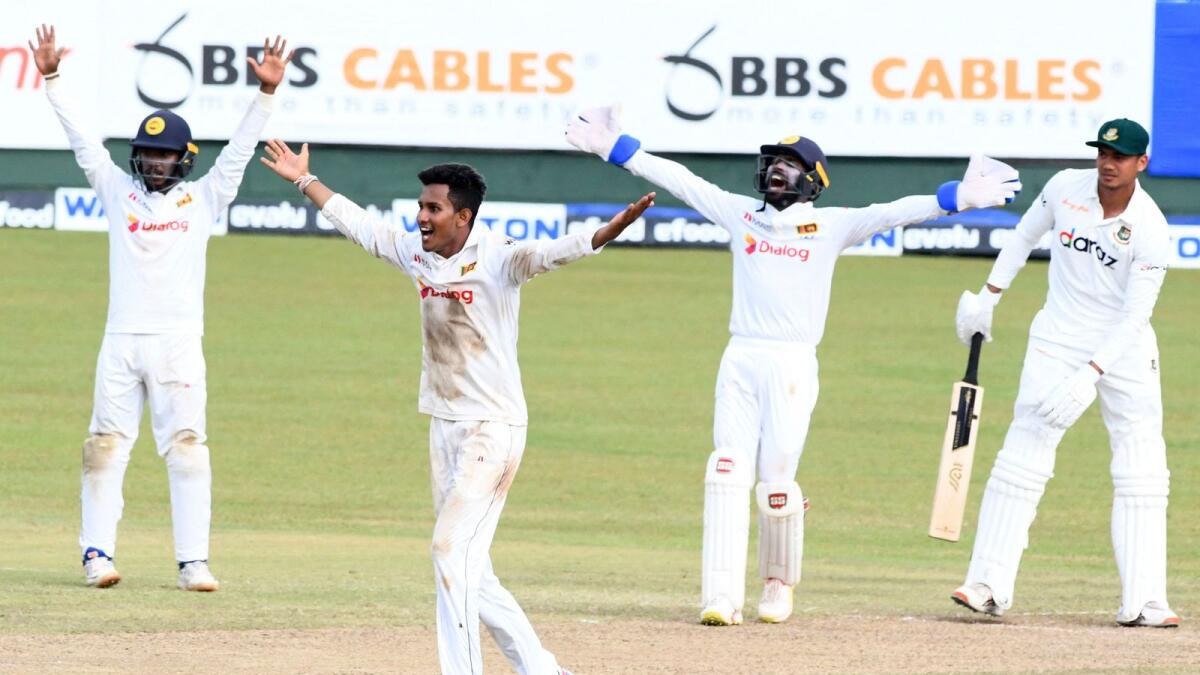Sri Lanka's Praveen Jayawickrama (second left) celebrates with teammates after he dismissed Bangladesh's Taskin Ahmed during the third day of the second and final Test. — AFP