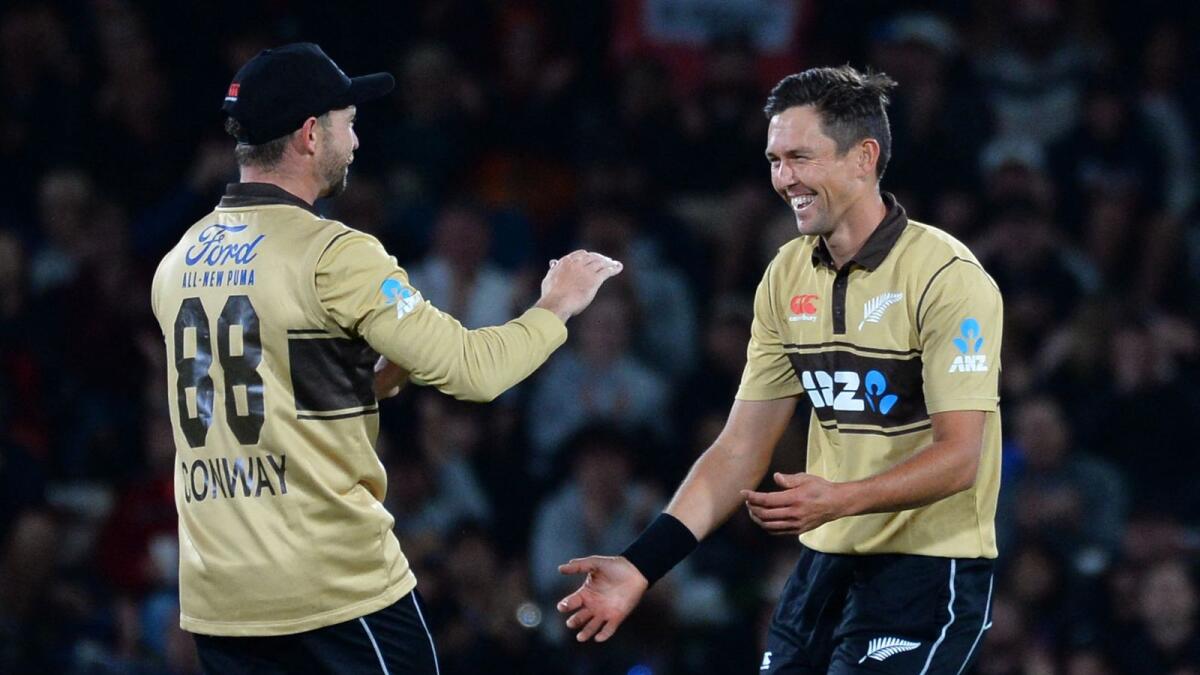 New Zealand's Devon Conway (left) and Trent Boult celebrate the dismissal of Australia's Josh Philippe. — AFP