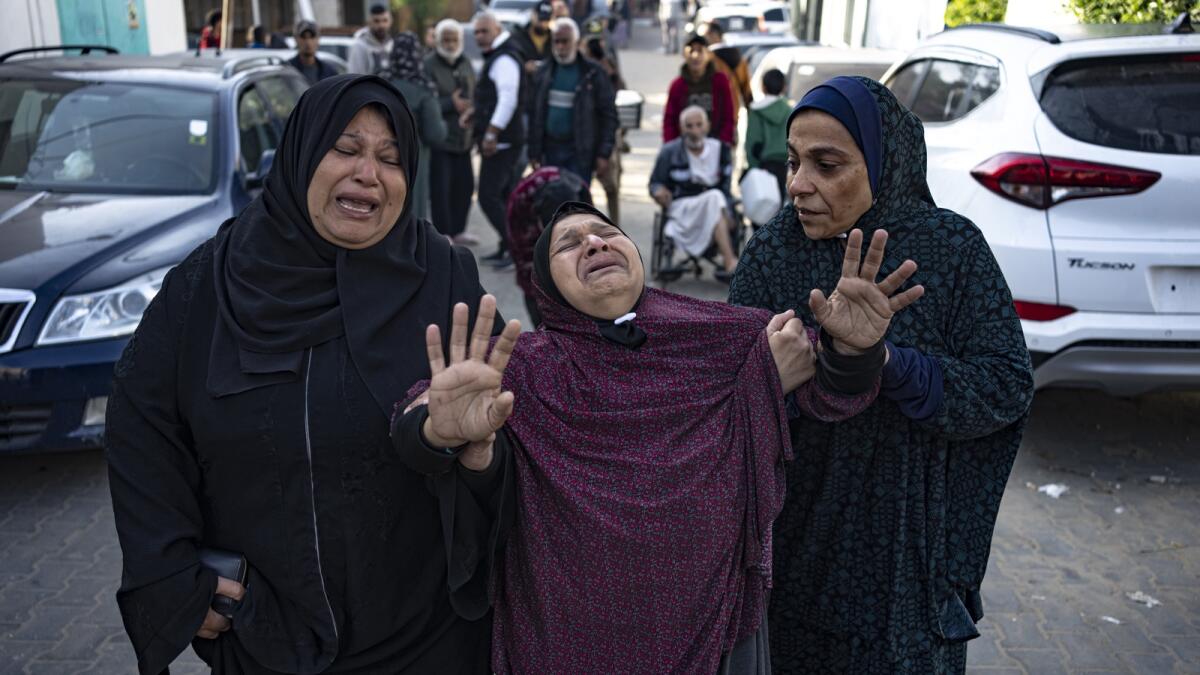 Palestinians mourn their relatives killed in the Israeli bombardment of the Gaza Strip, in the hospital in Khan Younis. - AP