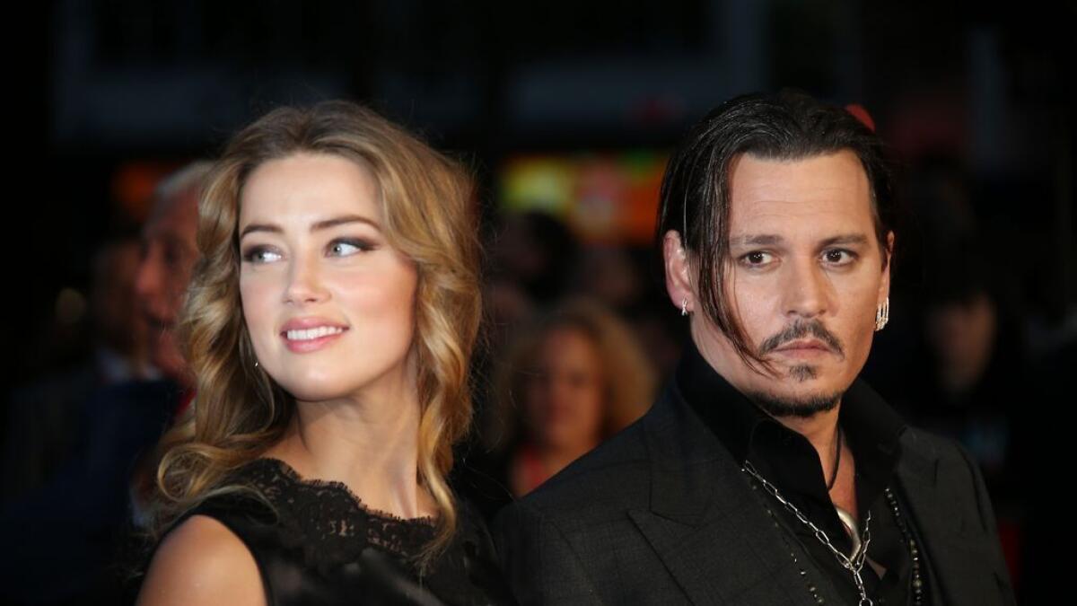 Amber Heard, left, and Johnny Depp arrive at the premiere of Depp's film 'Black Mass,' at the London film festival 2014