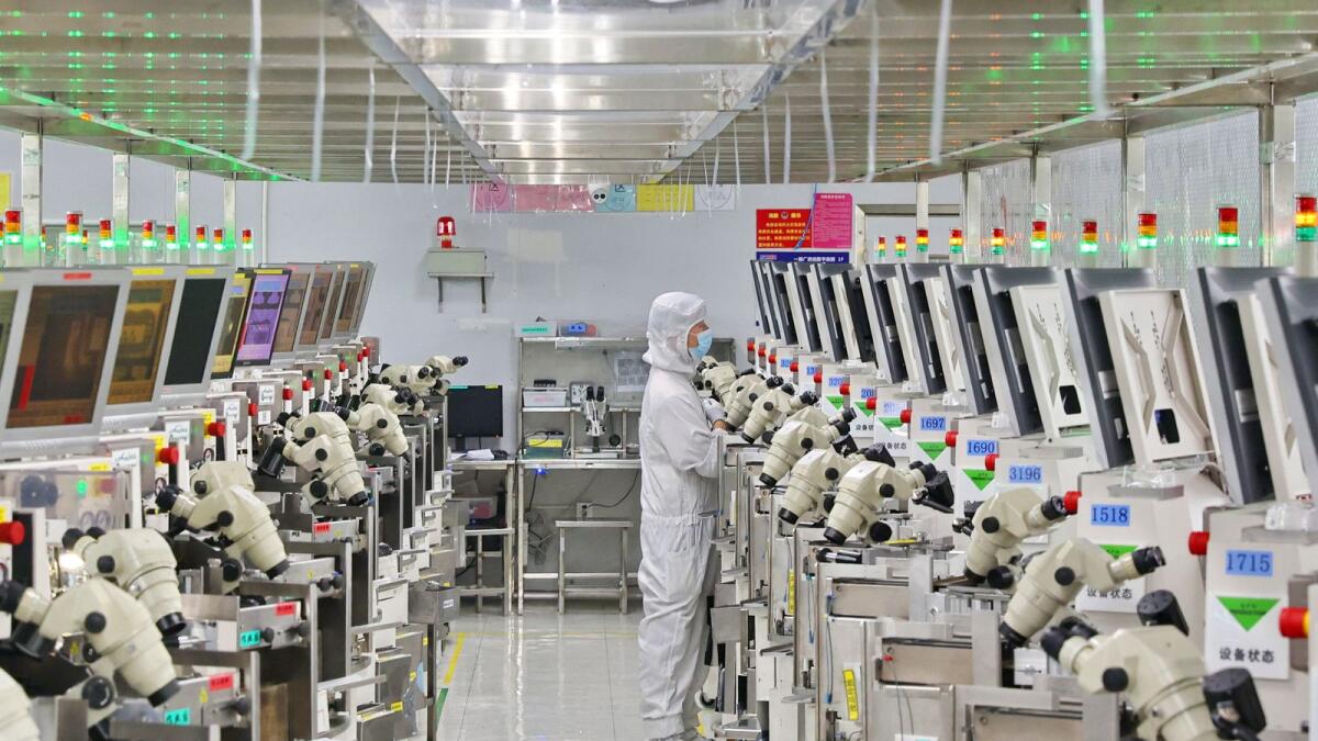 A man works at a manufacturer of Integrated Chip encapsulation in Nantong in eastern China's Jiangsu province. The US, Dutch and Japanese curbs have directly hit some of China's biggest chip manufacturers. - AP