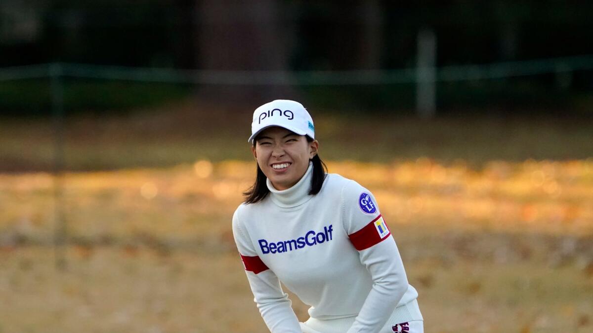 Hinako Shibuno reacts to a chip shot that almost went into the cup on the 17th green. — AP