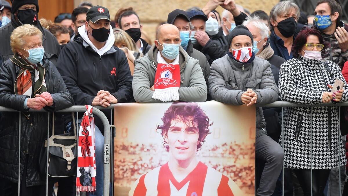 Vicenza fans and people wait near the Vicenza Cathedral with an image in tribute to former Italy player Paolo Rossi before the start of the funeral. — Reuters
