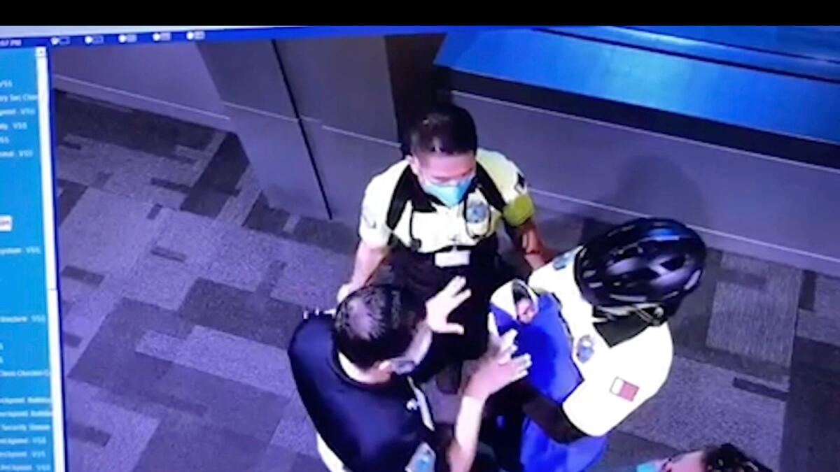 This image made from the Oct. 2, 2020, surveillance camera footage obtained by the website Doha News shows officials care for an abandoned baby at Hamad International Airport in Doha, Qatar.