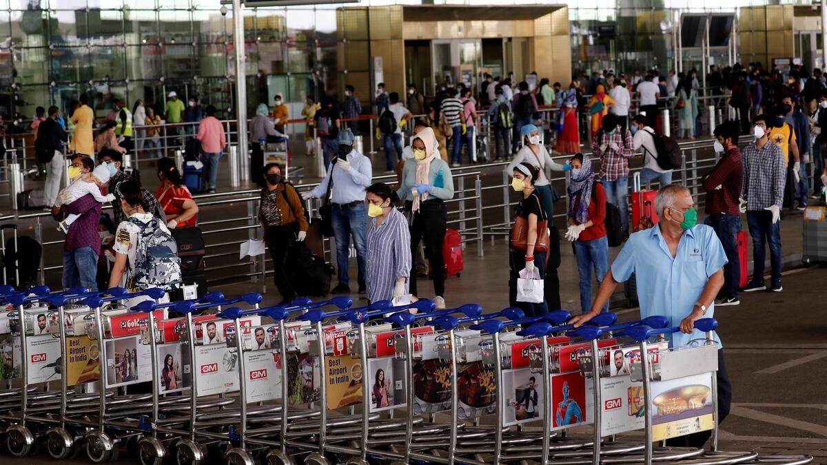 An airport staff member pushes trollies at the entrance of Chhatrapati Shivaji International Airport, after the government allowed domestic flight services to resume, during an extended nationwide lockdown to slow the spread of the coronavirus disease (COVID-19), in Mumbai, India, May 25, 2020.