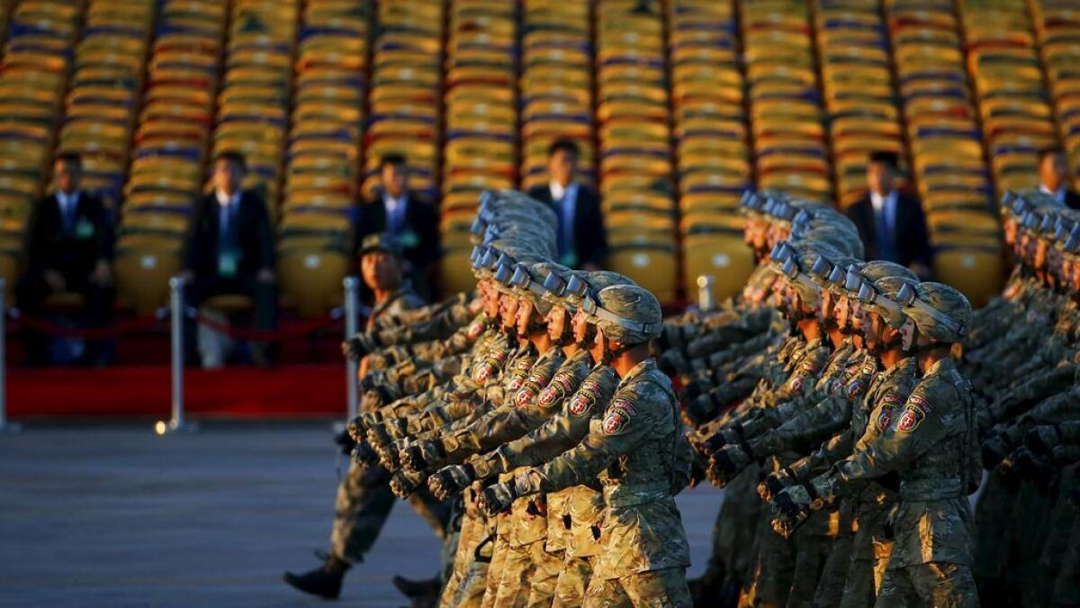 Soldiers of the Peoples Liberation Army (PLA) of China march in formation past the Tiananmen Square before a military parade to mark the 70th anniversary of the end of World War Two, in Beijing, China, September 3, 2015.  
