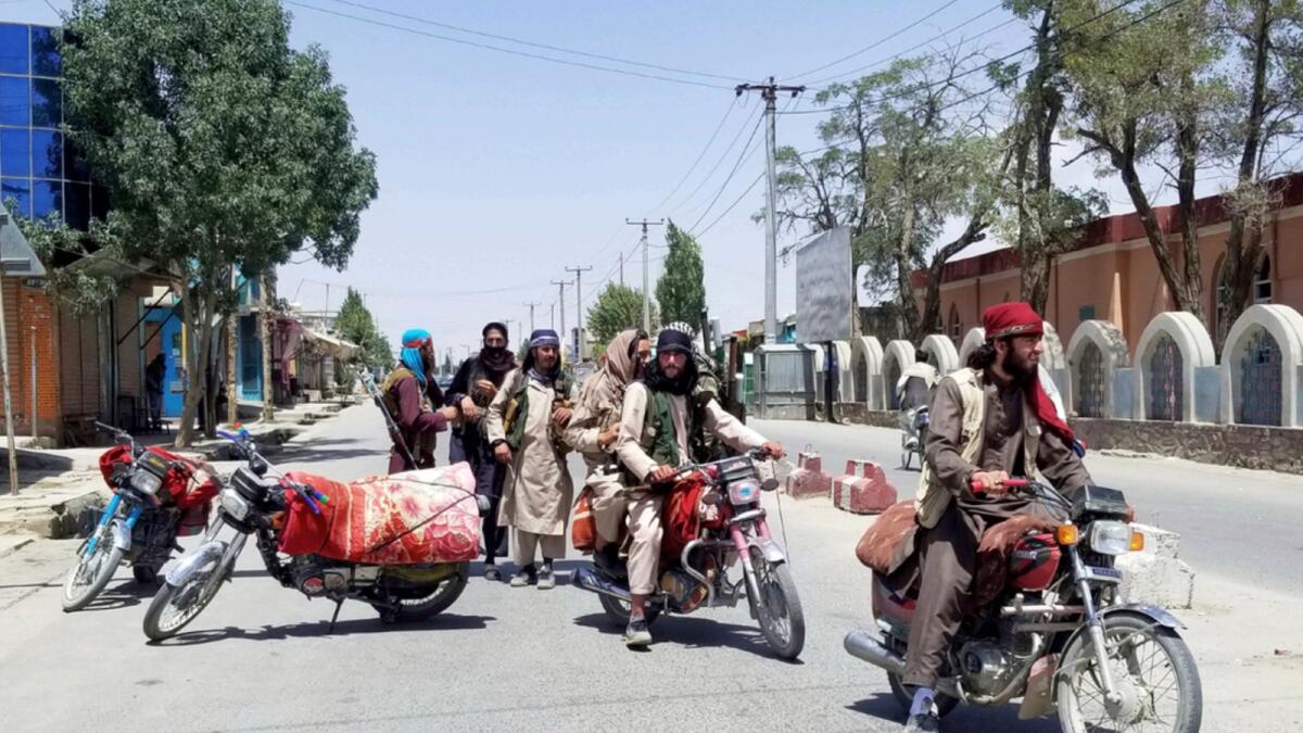 Taliban fighters patrol inside the city of Ghazni, southwest of Kabul. — AP