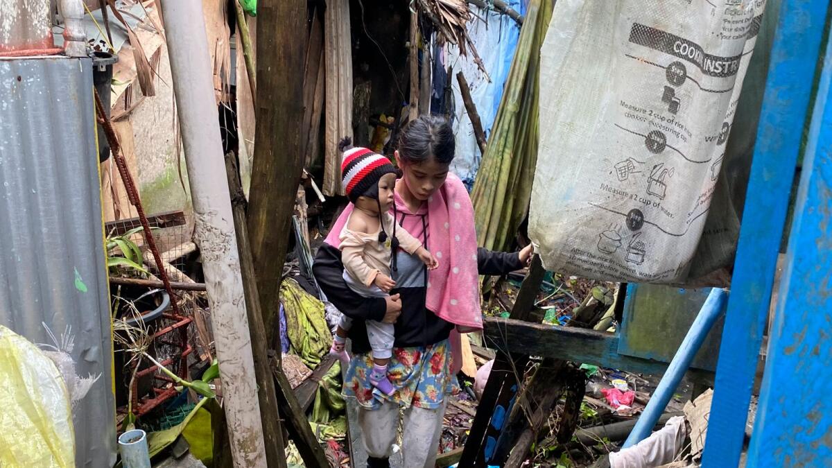 Residents walk past damages caused by an earthquake as they evacuate to safer grounds at Hinatuan town, Surigao del Sur province, southern Philippines on Sunday December 3, 2023. (Photo: AP)