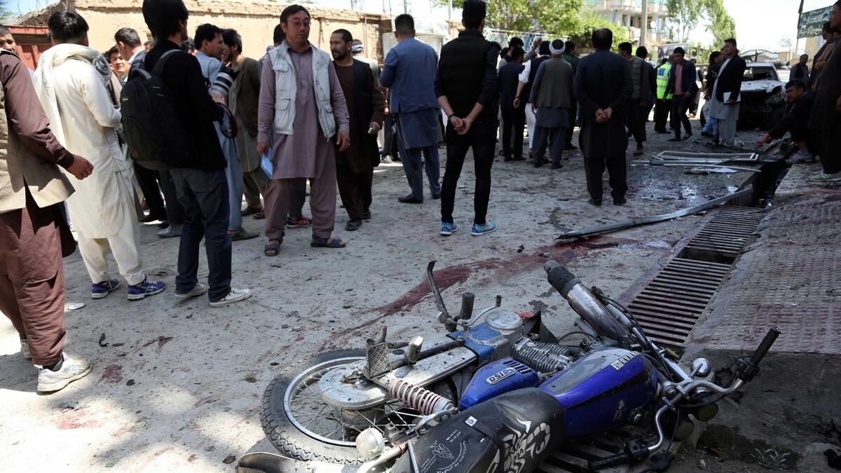People gather outside a voter registration center which was attacked by a suicide bomber in Kabul, Afghanistan.-AP 