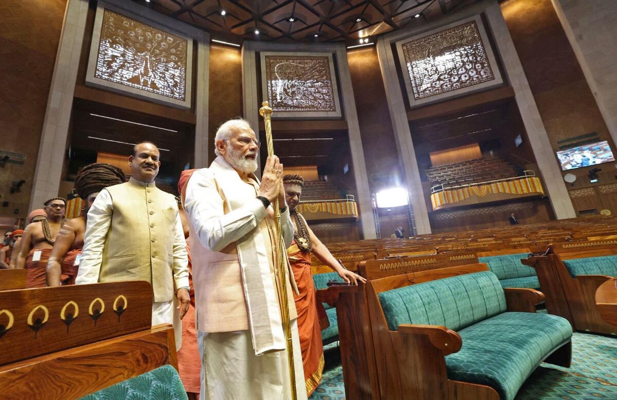 India's Prime Minister Narendra Modi carrying the Sengol, a Tamil sceptre during the inauguration ceremony of the new parliament building in New Delhi. Photo: AFP