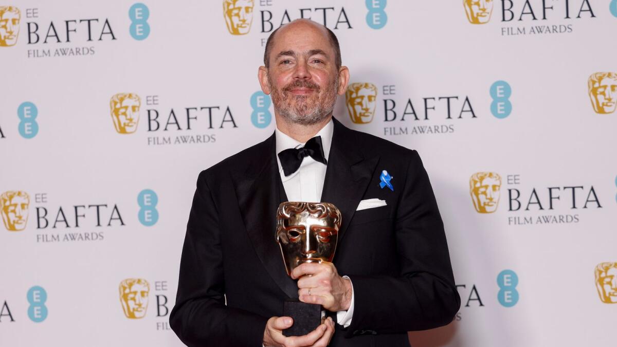Edward Berger poses for photographers with the Director Award for the film 'All Quiet on the Western Front' at the 76th British Academy Film Awards. — AP