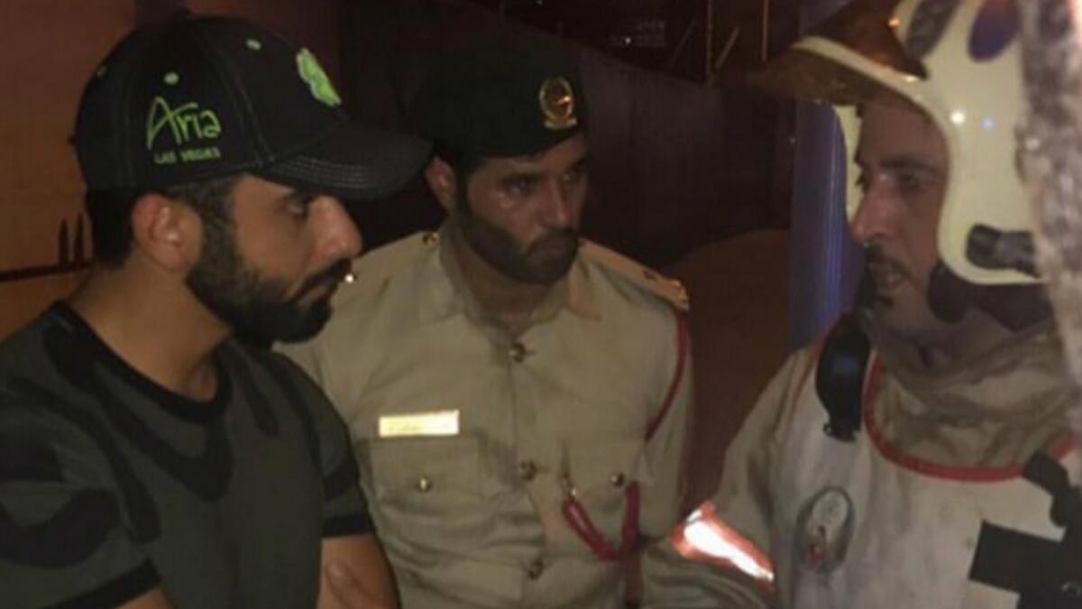 Sheikh Mansoor being briefed by a firefighter