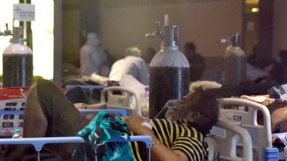 Covid-19 patient on oxygen support takes a rest at a temporarily converted isolation ward for Covid-19 patients in a Banquet Hall in New Delhi. — ANI