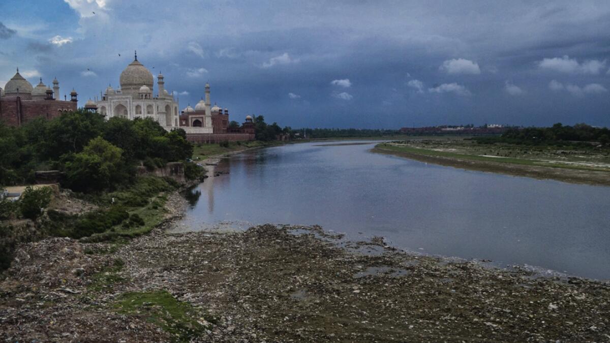 Yamuna river flows beside the historic Taj Mahal, in Agra. The water quality of the river, which had improved during lockdown, is deteriorating now due to various factors including rain washed garbage from drains emptying into the river. Photo: PTI