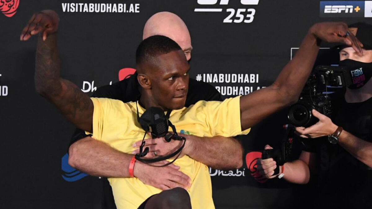 Israel Adesanya shows off a crane kick during the face-off before the UFC 253 main event in Abu Dhabi's Fight Island. - UFC Twitter