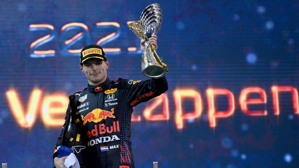 Formula One World champion Max Verstappen celebrates on the podium. (AFP)