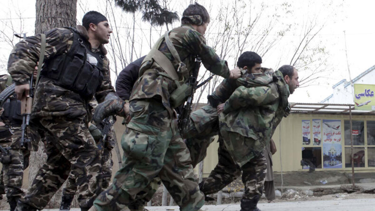 Afghan security personnel carry their wounded comrades during an operation near the Indian consulate in Mazar-i-Sharif, Afghanistan January 4, 2016. (Photo: Reuters)