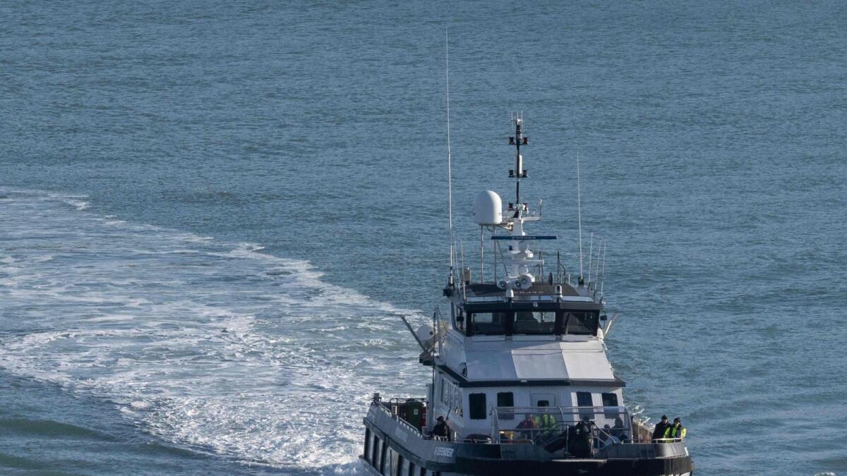 Migrants picked up at sea while attempting to cross the English Channel, arrive at the port on UK Border Force cutter 'BF Defender'  in Dover, southeast England. — AFP