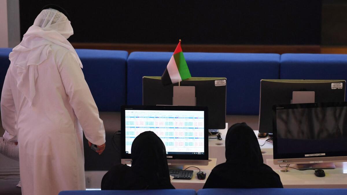 Traders at the Dubai Financial Market. — AFP
