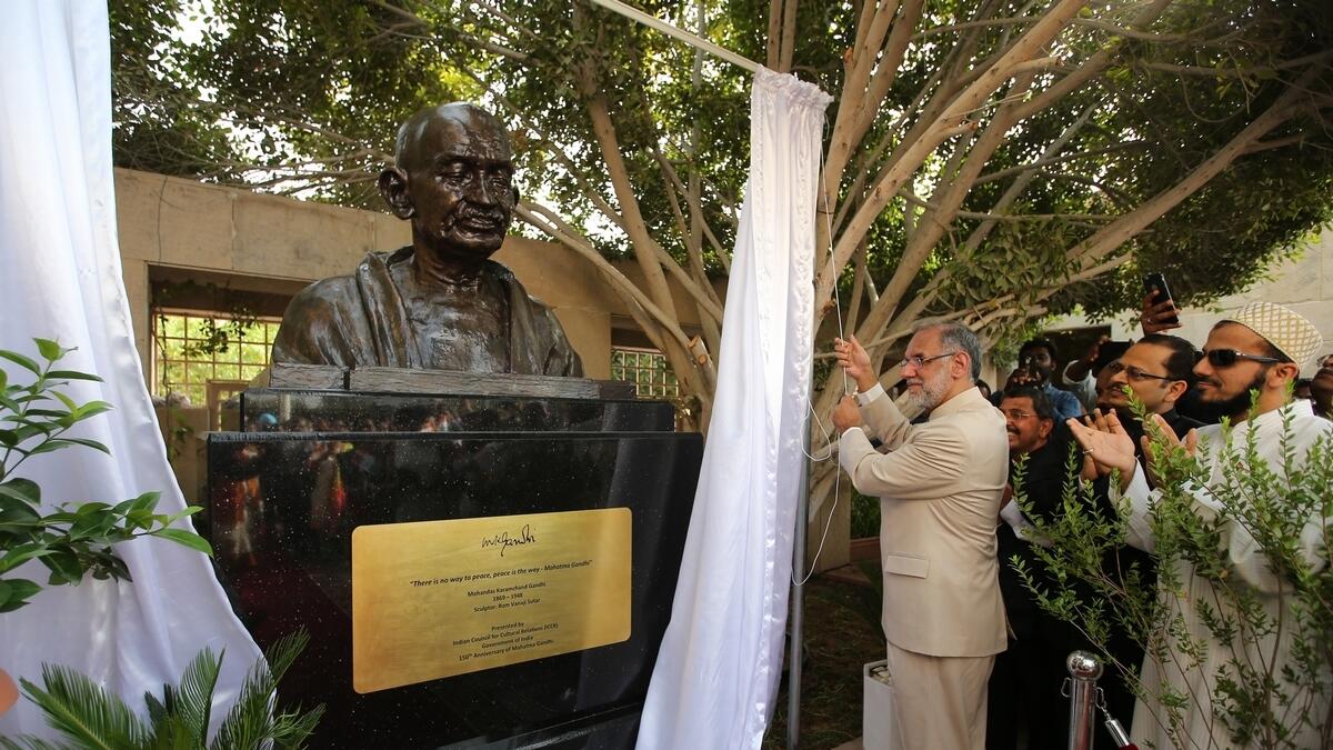 Navdeep Suri unveil the statue of Mahatma Gandhi during India's 73rd Independence day celebrations at the Embassy in Abu Dhabi.-Photo by Ryan Lim/Khaleej Times