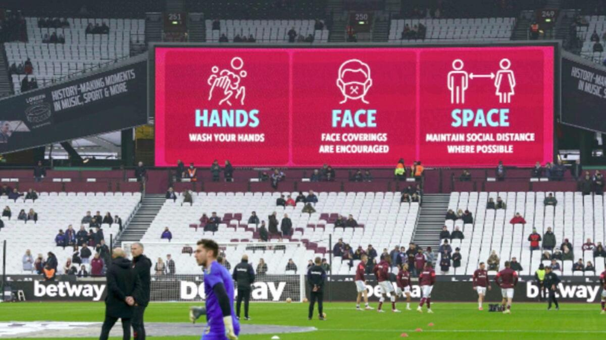 Covid-19 safety signage are seen above the stands before the English Premier League soccer match between West Ham and Southampton, at the London Stadium. — AP
