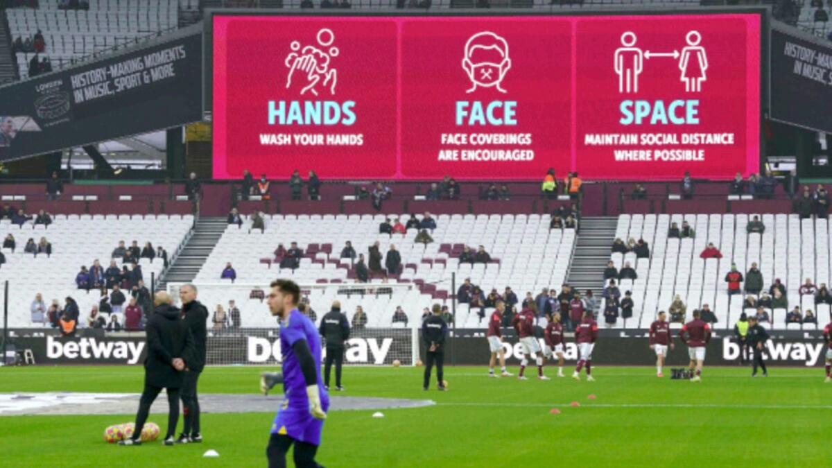 Covid-19 safety signage are seen above the stands before the English Premier League soccer match between West Ham and Southampton, at the London Stadium. — AP