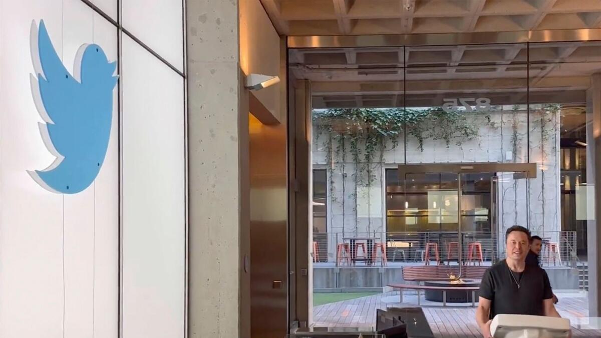 This image from the Twitter page of Elon Musk shows Musk entering Twitter headquarters carrying a sink through the lobby area on Wednesday.  (Twitter page of Elon Musk via AP)