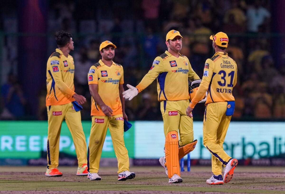 Chennai Super Kings captain MS Dhoni celebrates with teammates after qualifying for the IPL play-offs following their dominant victory over Delhi Capitals on Saturday. — PTI