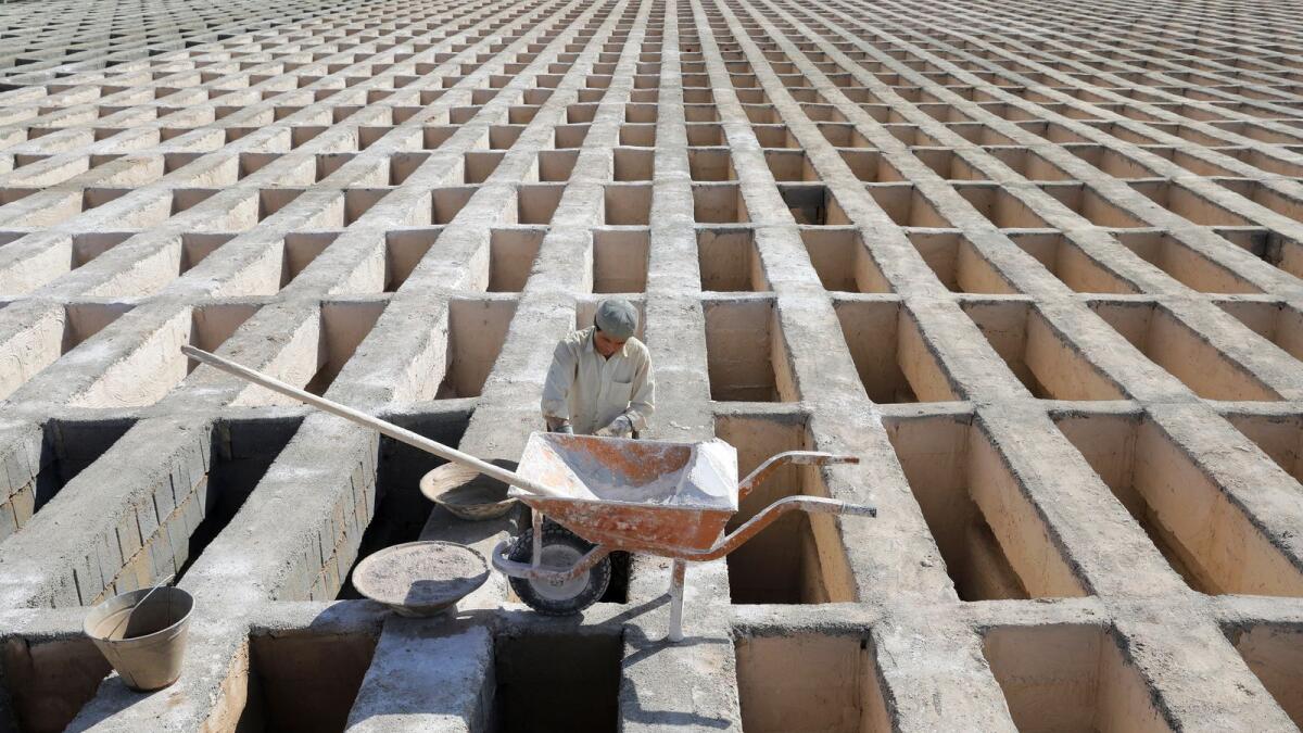 A cemetery worker prepares new graves at the Behesht-e-Zahra cemetery on the outskirts of the Iranian capital, Tehran.