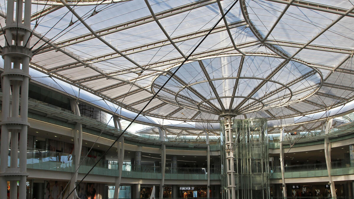 In this July 4, 2016 photo, the sun sets through the roof glass above one of the new Abdali Mall's light tubes, which redirects sunlight from the roof to the basement of Jordan's first energy-efficient shopping complex in Amman, Jordan.  Advocates for green building say sustainable building development is important in Jordan, where energy and water resources are quickly diminishing. (Layla Quran/AP Photo)