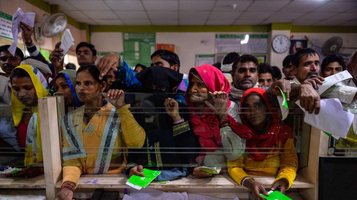 Villagers wait inside the bank to make the transactions in Uttar Pradesh state. India's government is expected to ramp up spending in its latest budget, seeking to ease the pain from a ban on high-value banknotes that slammed the brakes on the world's fastest-growing major economy.  AFP