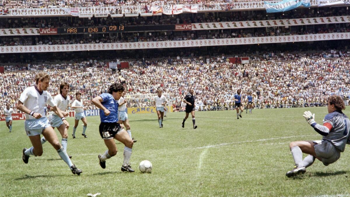 After dribbling past four English outfield players, Diego Maradona sells the finest of dummies to goalkeeper Peter Shilton (right) to score his second goal in the World Cup quarterfinal on June 22, 1986, in Mexico City. (AFP)
