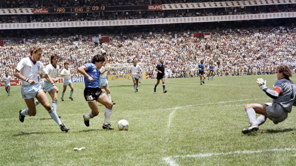 After dribbling past four English outfield players, Diego Maradona sells the finest of dummies to goalkeeper Peter Shilton (right) to score his second goal in the World Cup quarterfinal on June 22, 1986, in Mexico City. (AFP)